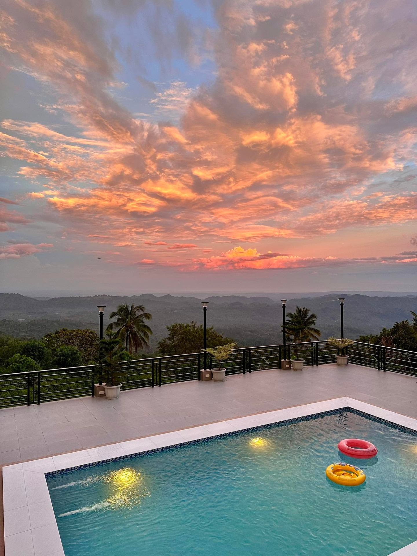Pool at sunset with clouds over the mountains