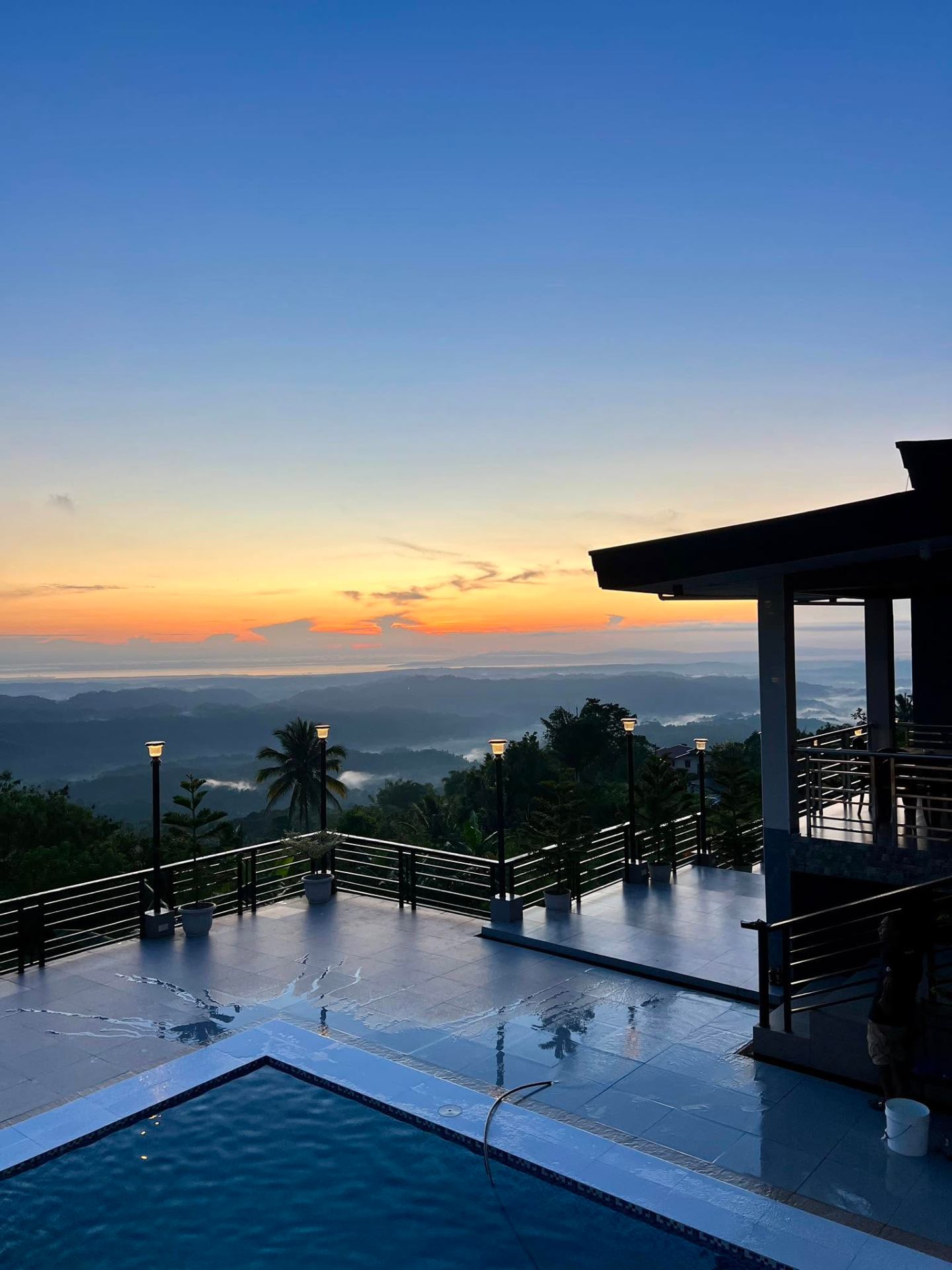 Villa de Eduardo infinity pool at sunrise overlooking the mountains of Davao